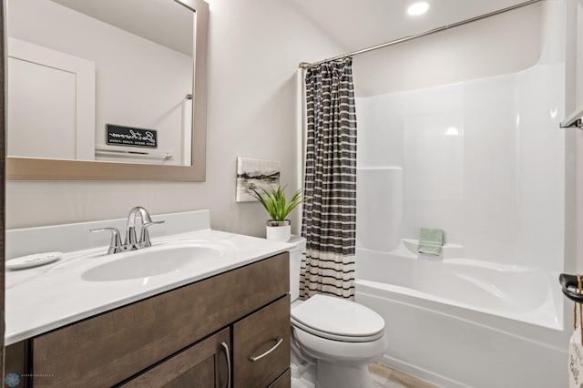 full bathroom featuring vanity, shower / tub combo, and toilet