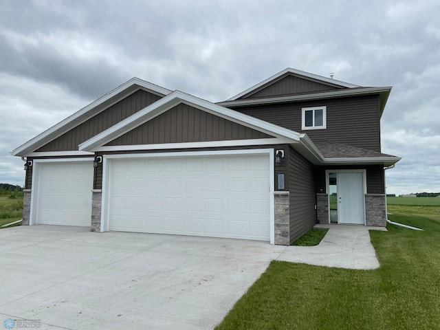 craftsman-style home with a front lawn and a garage