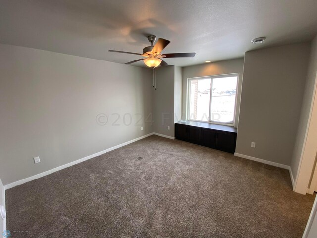 unfurnished room featuring carpet flooring and ceiling fan