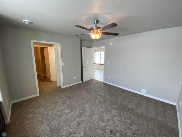 unfurnished bedroom with ceiling fan and carpet floors