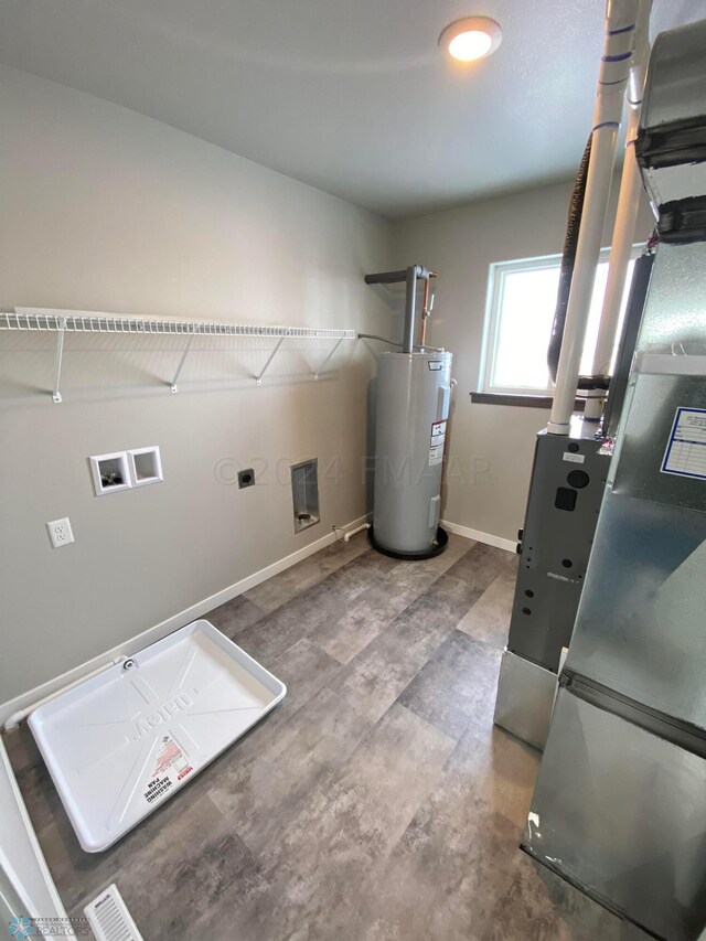 washroom featuring hookup for a washing machine, electric water heater, and hardwood / wood-style floors