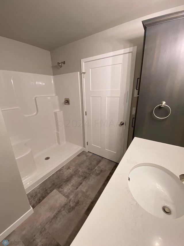 1316 Southview Dr SW, Glyndon, MN 56547 - full bath with vanity, a shower, and wood finished floors