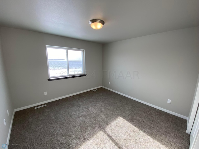 1316 Southview Dr SW, Glyndon, MN 56547 - unfurnished room featuring dark carpet and baseboards