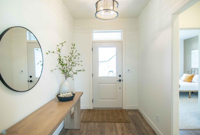 foyer featuring an inviting chandelier and hardwood / wood-style flooring