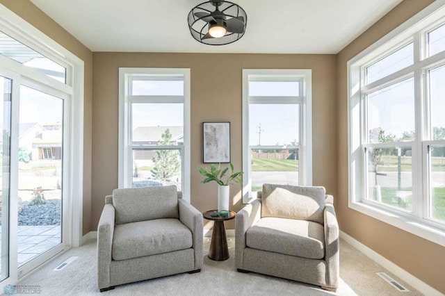 living area with light carpet and a wealth of natural light