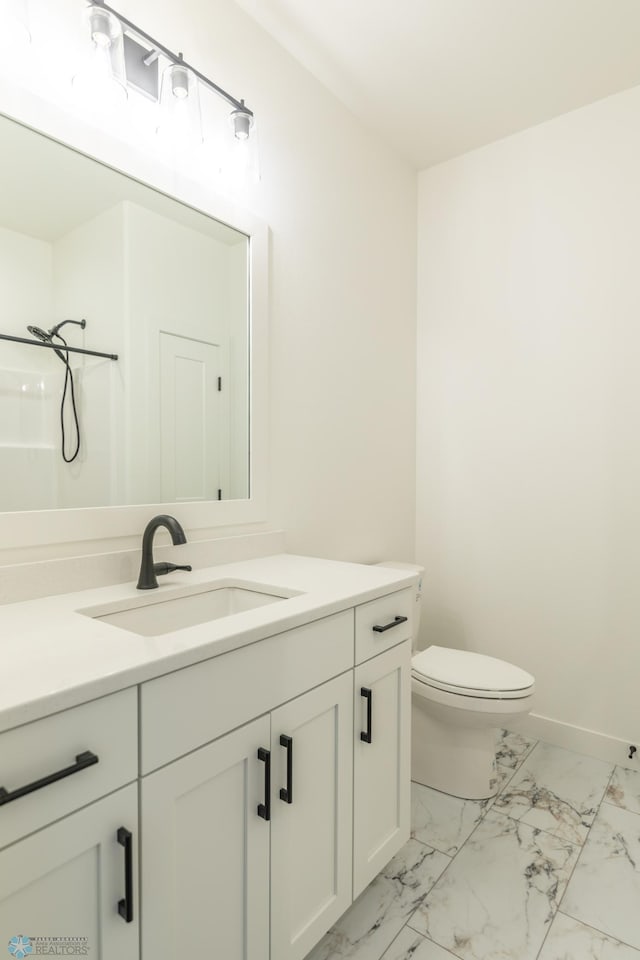 bathroom featuring a shower, vanity, and toilet