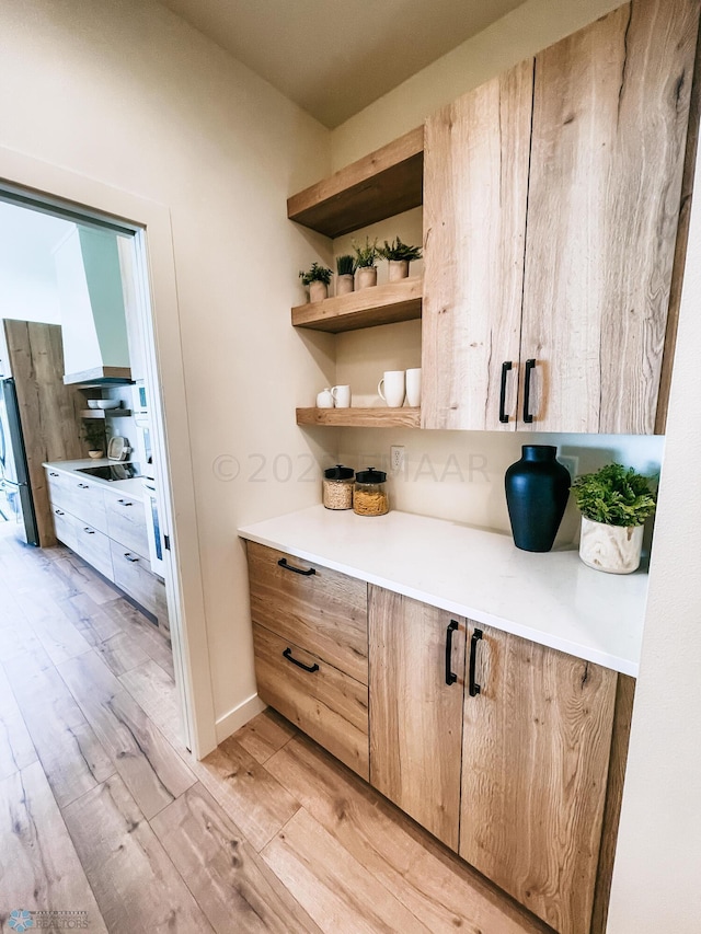 bar featuring light hardwood / wood-style flooring