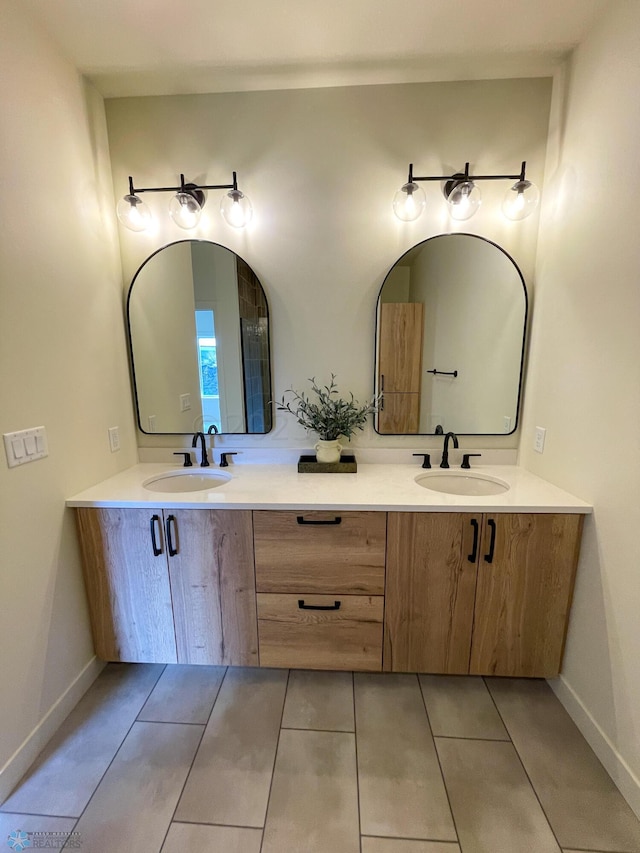 bathroom featuring tile patterned flooring and vanity