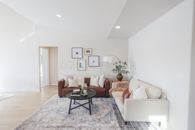 living room with lofted ceiling and light wood-type flooring