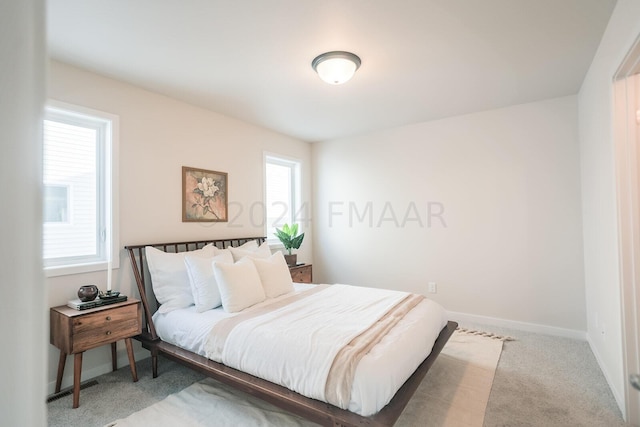 carpeted bedroom featuring multiple windows