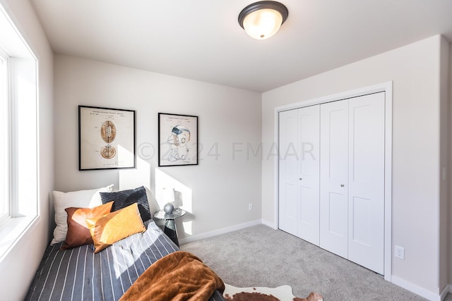 bedroom featuring a closet and light carpet