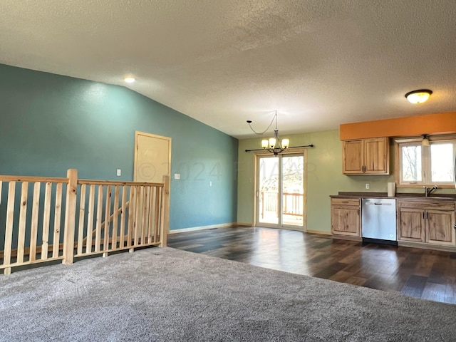 kitchen featuring dark countertops, plenty of natural light, pendant lighting, and stainless steel dishwasher