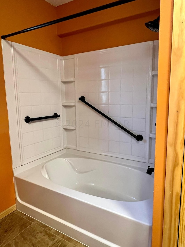 full bath with  shower combination, tile patterned flooring, and baseboards