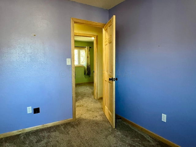 carpeted spare room with baseboards