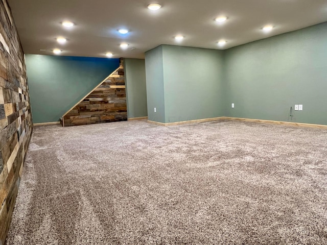 finished below grade area featuring carpet, baseboards, recessed lighting, and stairs