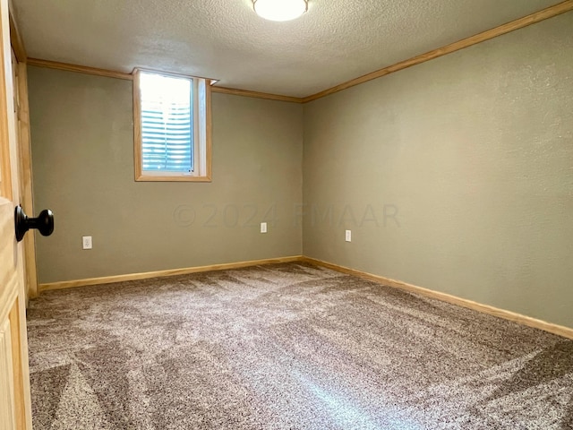 unfurnished room with baseboards, carpet, ornamental molding, and a textured ceiling