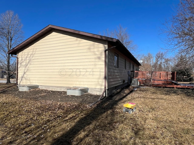 view of property exterior featuring central AC and a wooden deck