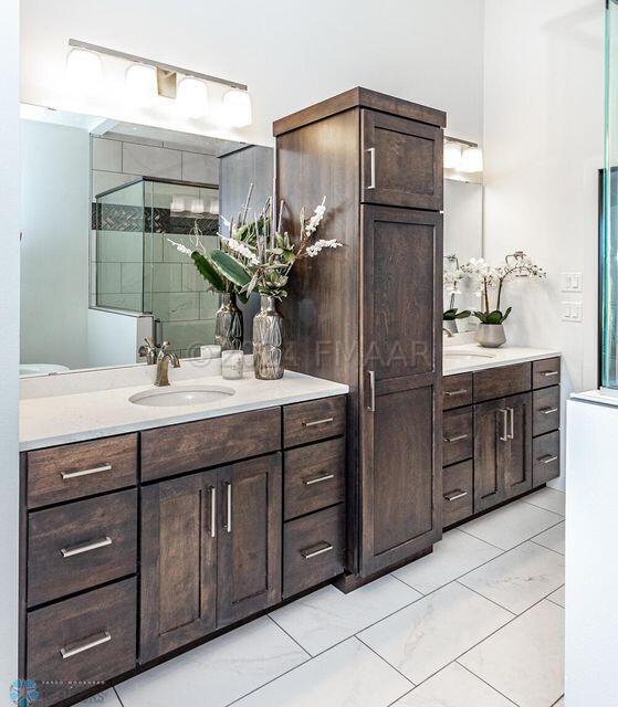 bathroom with tile flooring and large vanity