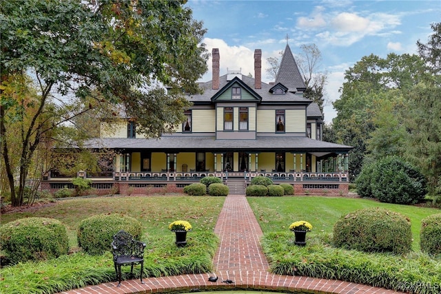 victorian home with a porch and a front yard