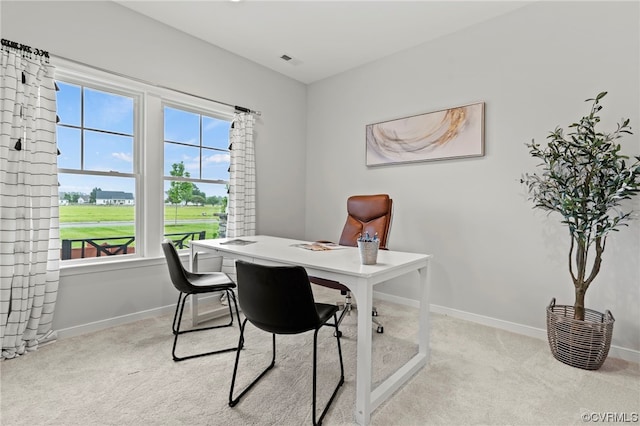 carpeted home office with a healthy amount of sunlight