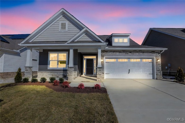 craftsman inspired home with a garage, a porch, and a yard