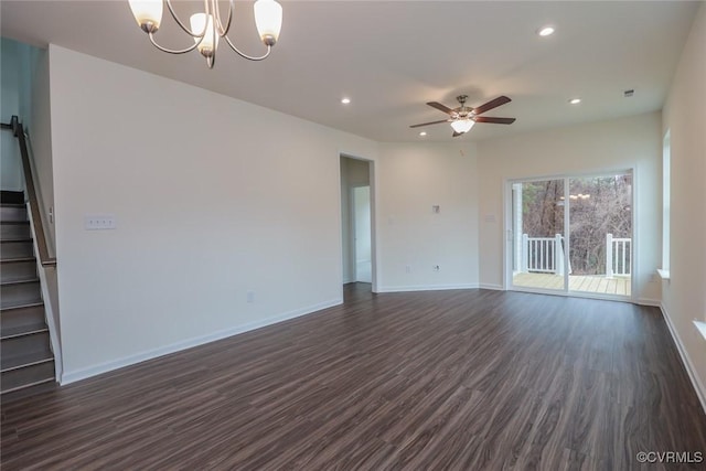 unfurnished living room featuring dark hardwood / wood-style floors and ceiling fan with notable chandelier