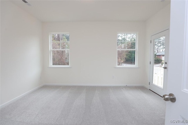 carpeted spare room with plenty of natural light