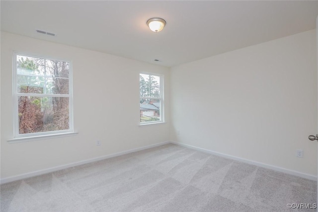 carpeted spare room with a wealth of natural light