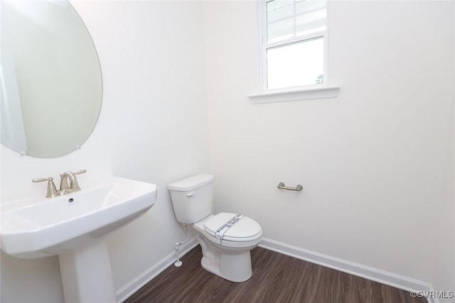 bathroom featuring hardwood / wood-style floors, sink, and toilet