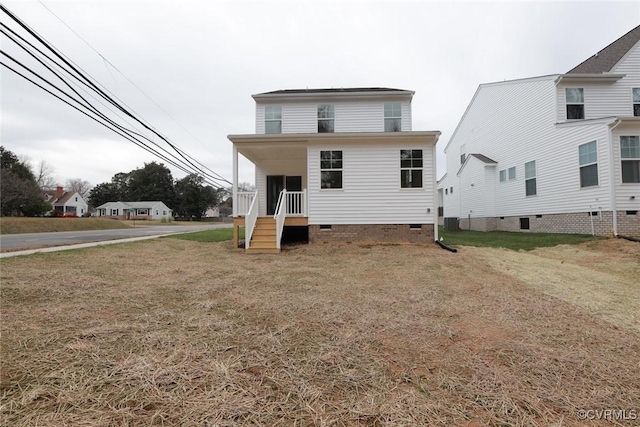 back of property featuring a lawn