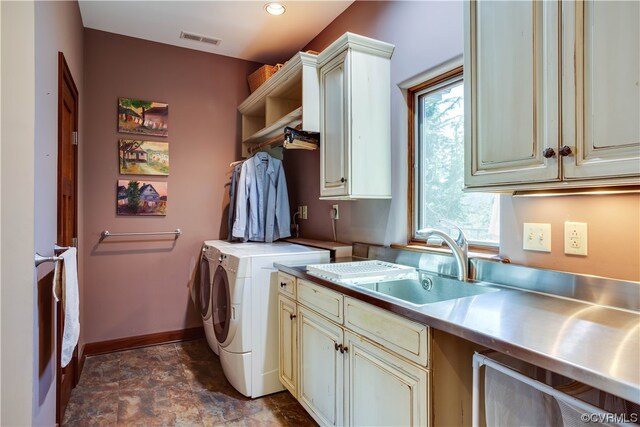 washroom with cabinets, sink, and independent washer and dryer