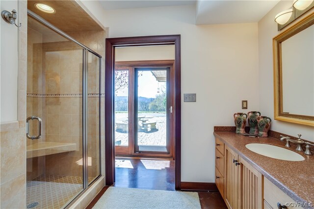 bathroom featuring vanity and a shower with shower door