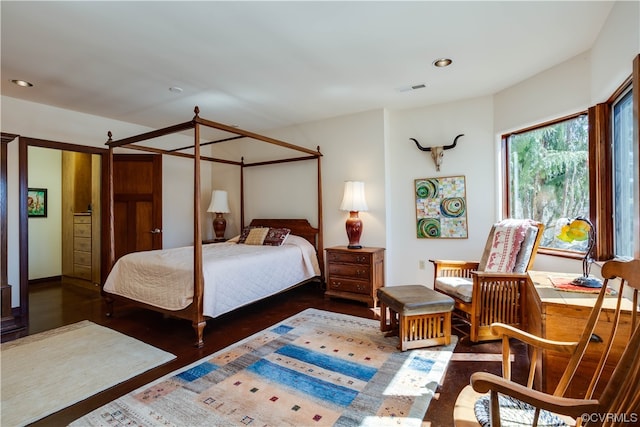 bedroom with dark wood-type flooring