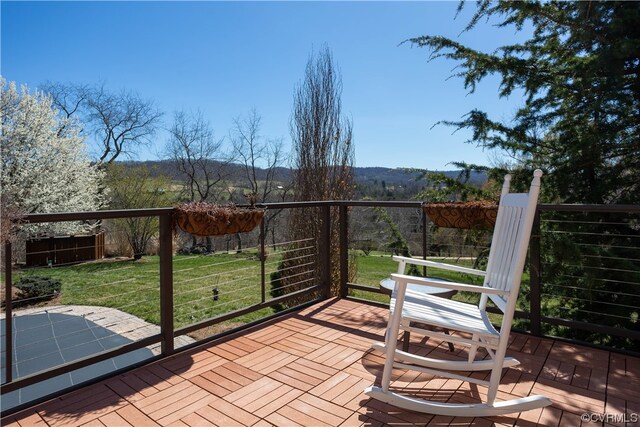 wooden terrace with a yard