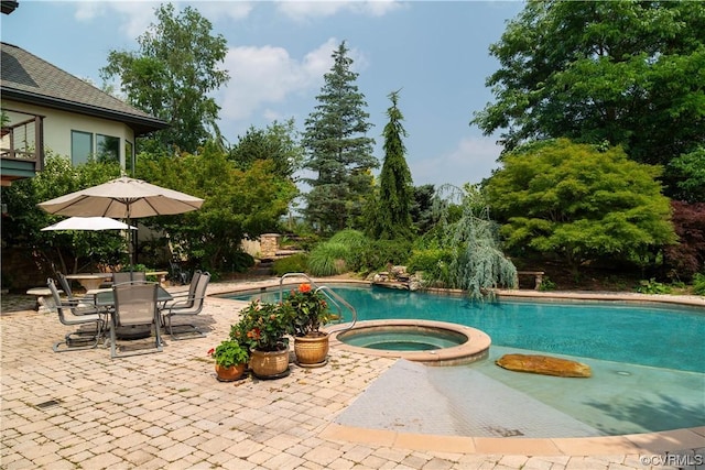 view of pool with an in ground hot tub and a patio