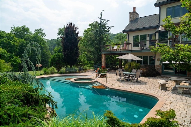 view of pool featuring an in ground hot tub and a patio