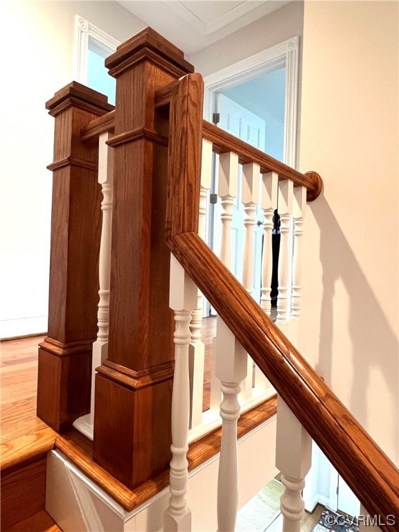 stairway with hardwood / wood-style floors