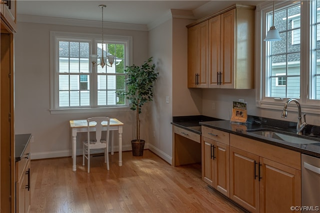 kitchen featuring dark stone countertops, light wood-type flooring, dishwasher, hanging light fixtures, and sink