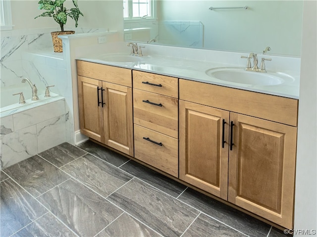 bathroom with tile patterned flooring, dual bowl vanity, and a relaxing tiled tub