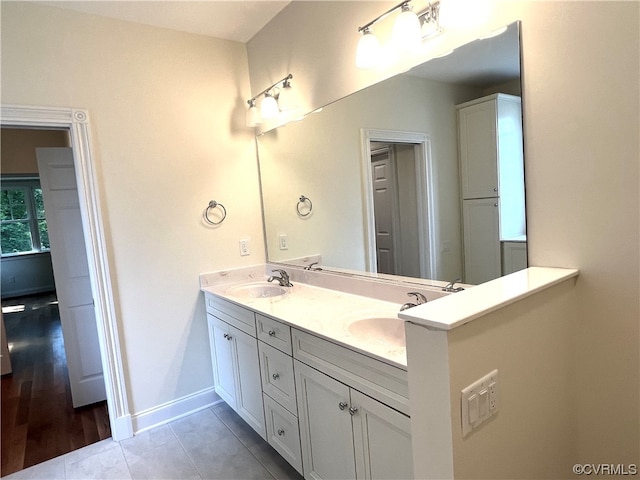 bathroom with tile patterned flooring and double vanity