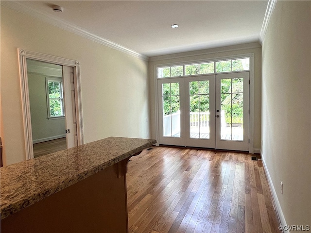 doorway to outside featuring wood-type flooring, french doors, and plenty of natural light