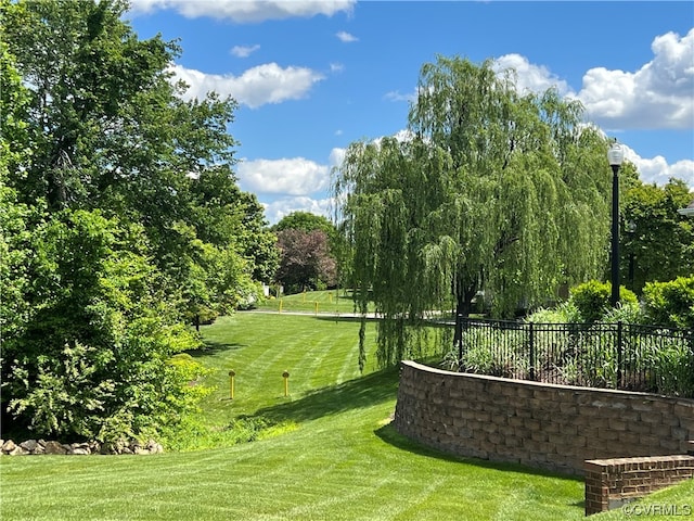 view of home's community featuring a yard and fence