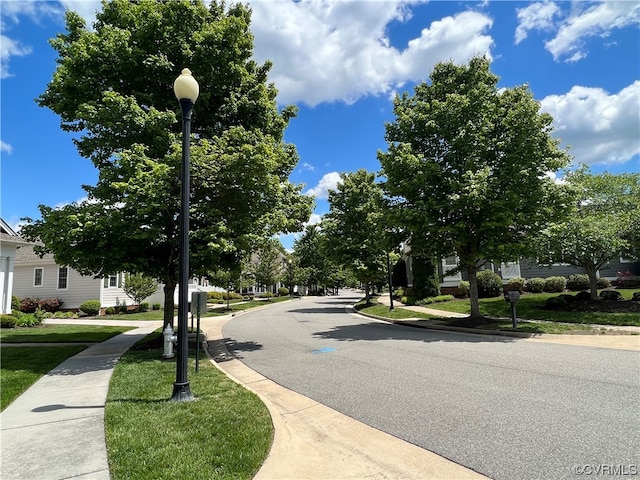 view of street with curbs, street lighting, and sidewalks