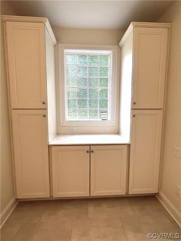 mudroom with light tile patterned floors and baseboards