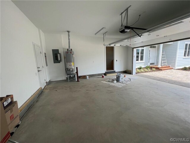 garage with gas water heater, electric panel, and a garage door opener