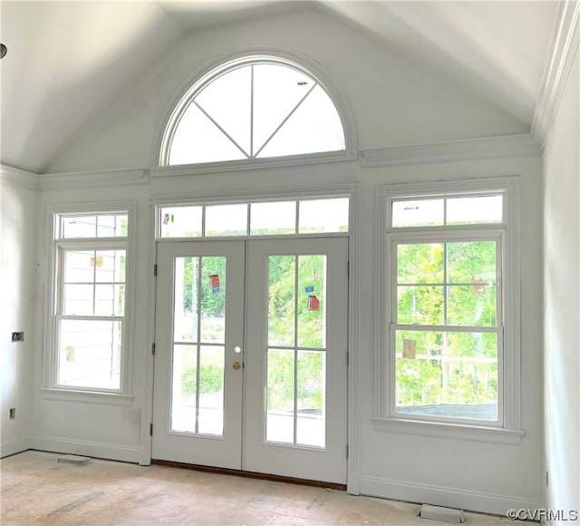 doorway with french doors, baseboards, and high vaulted ceiling