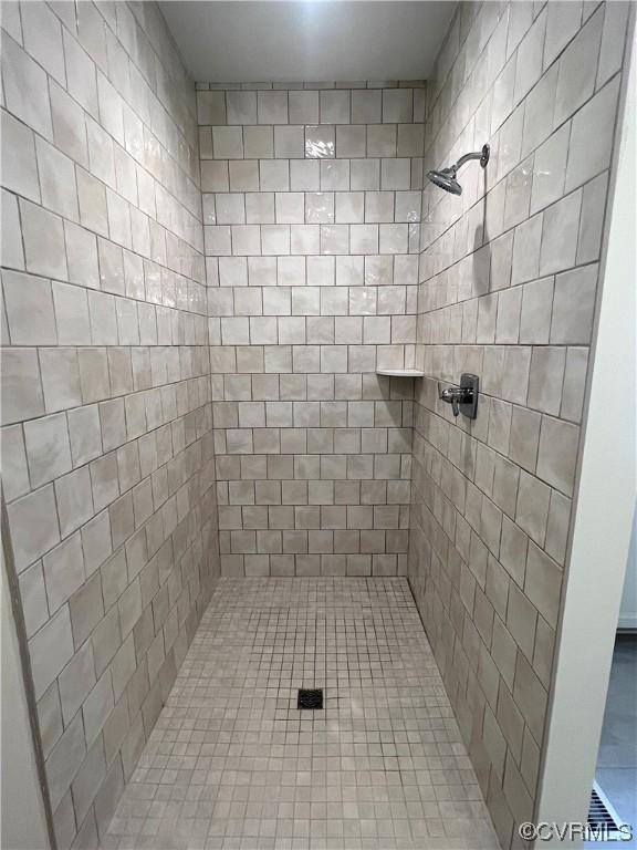 bathroom with a tile shower