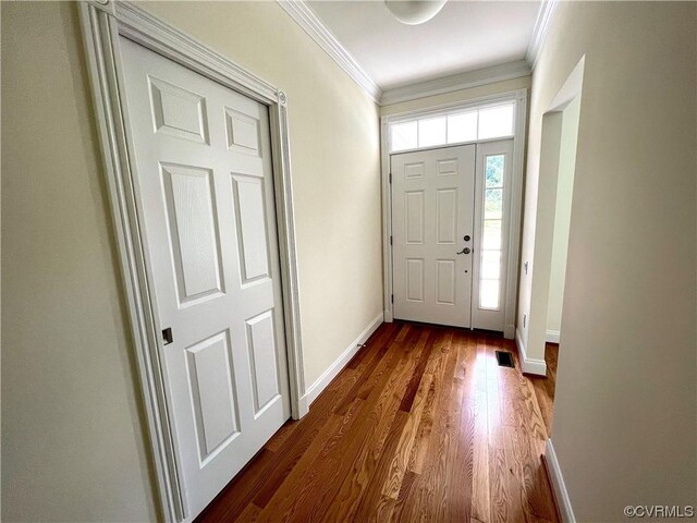 entryway with crown molding, dark wood-style floors, and baseboards