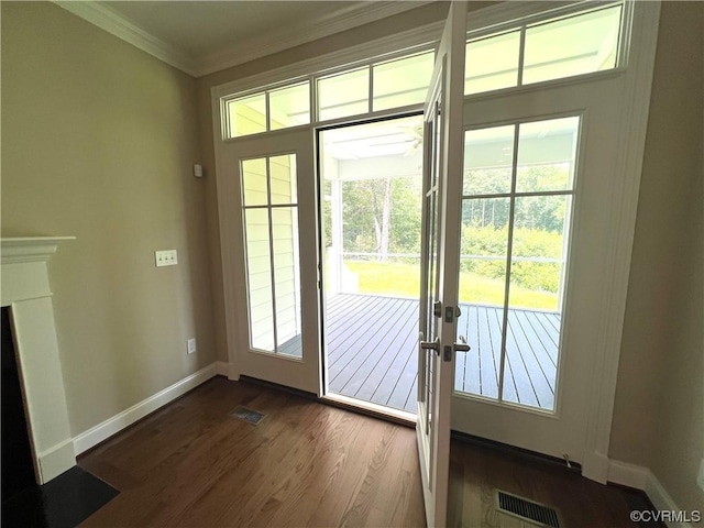 doorway to outside featuring visible vents, baseboards, dark wood-style floors, and ornamental molding