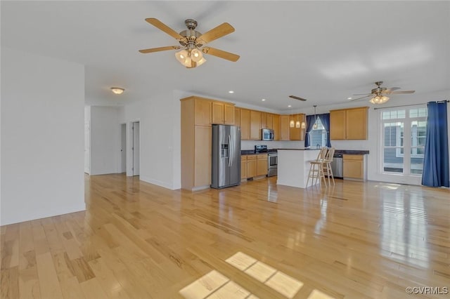 unfurnished living room with a ceiling fan, light wood-type flooring, and recessed lighting